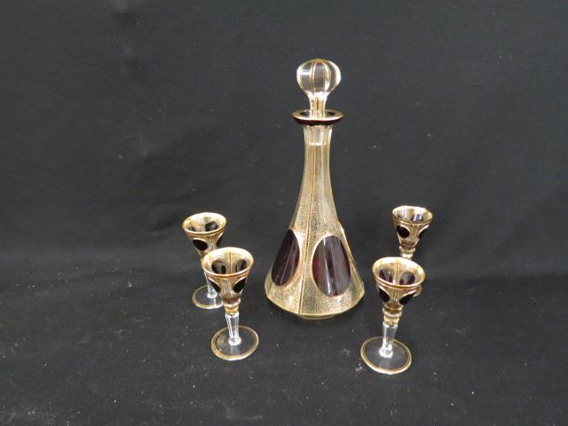 Appraisal: Moser Art Glass Decanter and Cordials oval ruby medallions gold