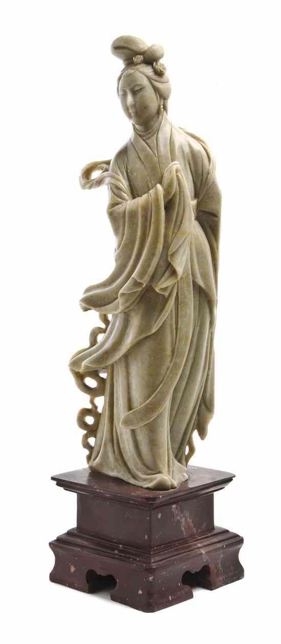 Appraisal: A Chinese Soapstone Figure depicting Guanyin raised on a pedestal