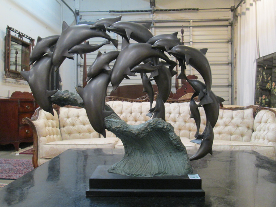 Appraisal: BRONZE MARINE WILDLIFE SCULPTURE a pod of dolphins arranged in