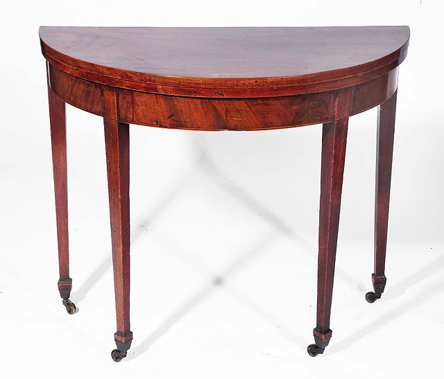 Appraisal: A th Century mahogany tea tablehalf round on tapering supports