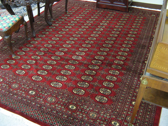 Appraisal: PAKISTANI BOKHARA CARPET overall Turkoman gol design on red ground