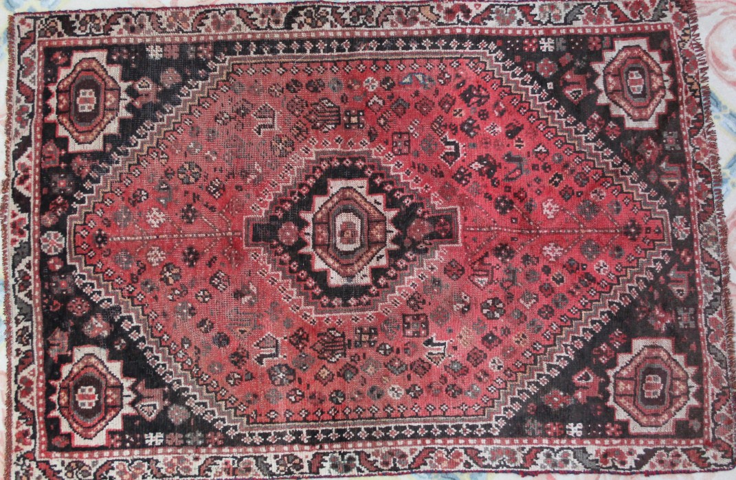 Appraisal: A Shiraz rug medallion style in red and cream cm