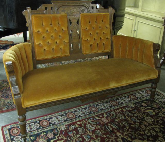 Appraisal: Late Victorian carved walnut settee circa tufted upholstery