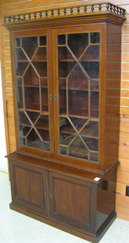 Appraisal: EDWARDIAN MAHOGANY BOOKCASE ON CABINET English c The George III