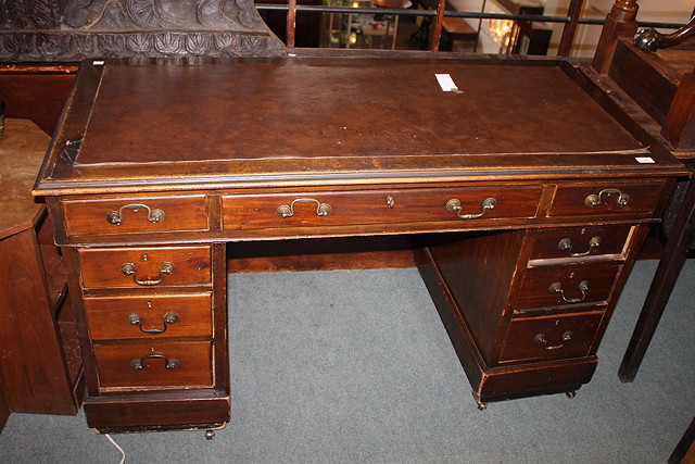 Appraisal: AN EDWARDIAN MAHOGANY PEDESTAL DESK with leatherette inset top above