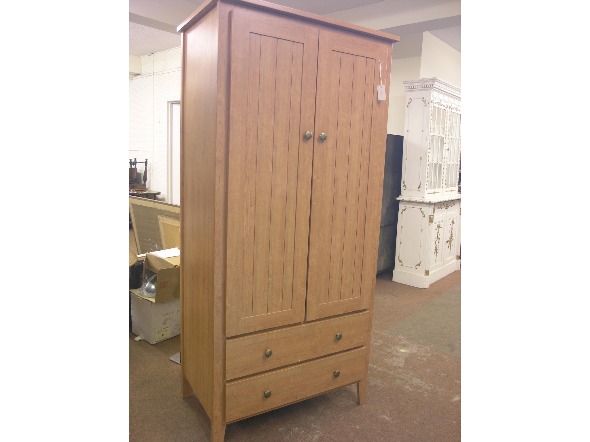 Appraisal: A modern cherry wood wardrobe enclosed by pair of doors