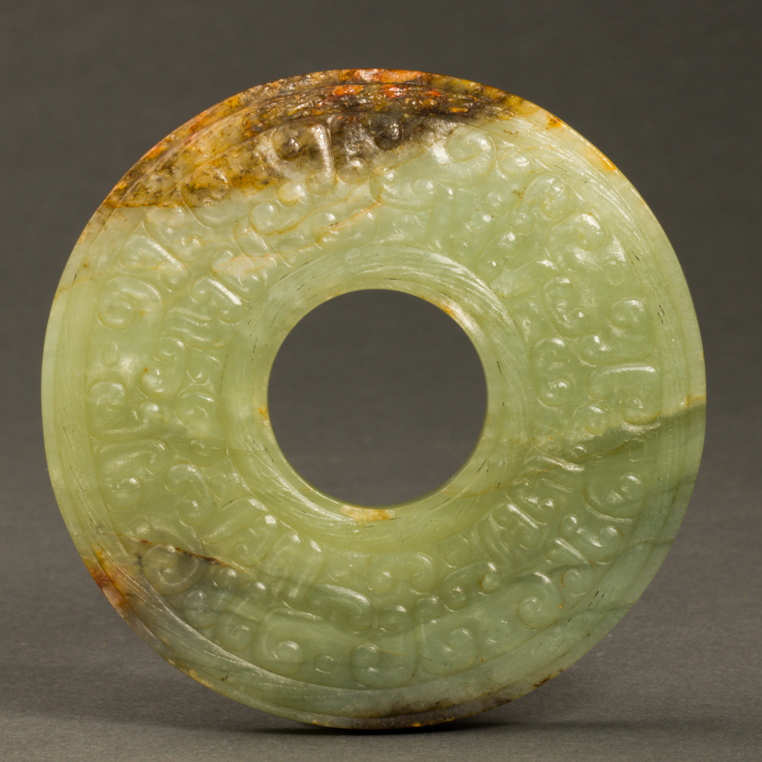 Appraisal: CHINESE RUSSET CELADON JADE BI DISC Chinese russet celadon jade