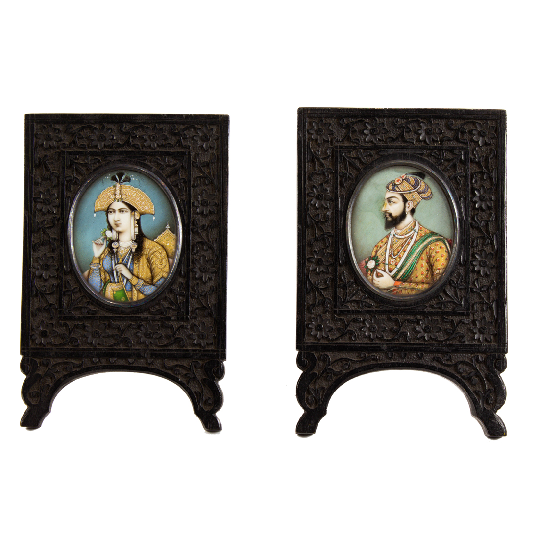 Appraisal: A PAIR OF INDIAN PORTRAIT MINIATURES IN CARVED EBONY FRAMES