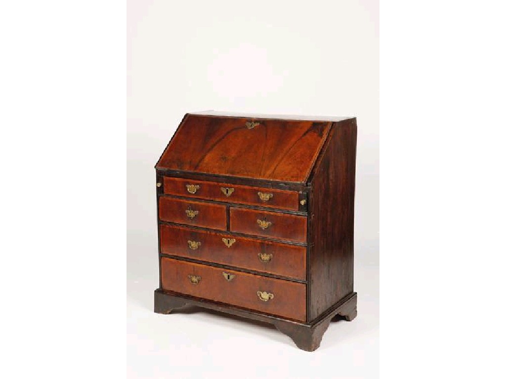 Appraisal: A GEORGE III WALNUT VENEERED BUREAU the sloping fall with