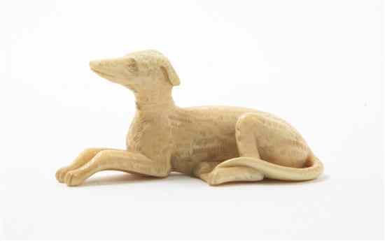 Appraisal: A Chinese Carved Ivory Dog the animal in a recumbent