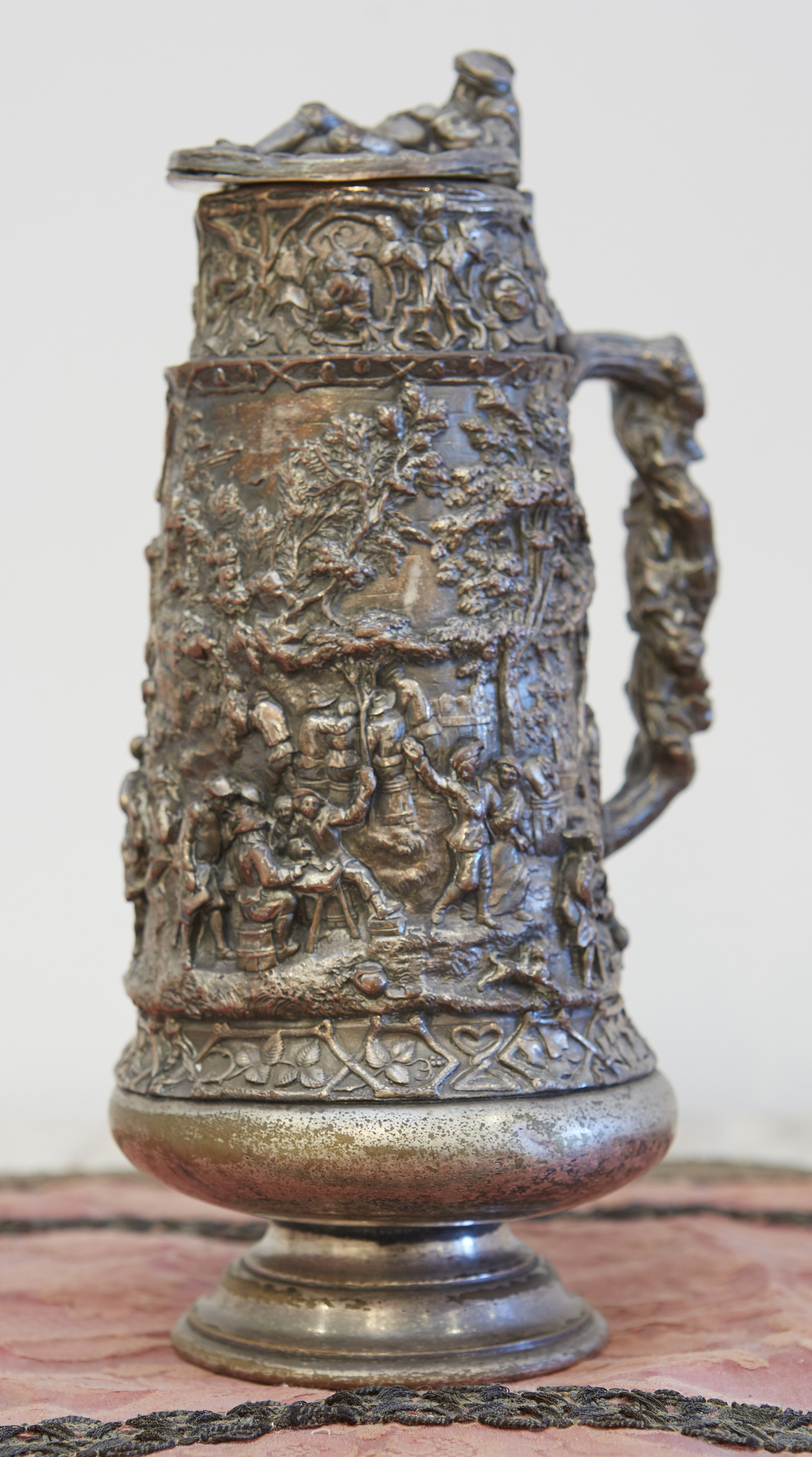 Appraisal: A GERMAN SILVER PLATE STEIN Profusely embellished in relief with