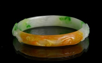 Appraisal: An Impressive Carved Jadeite Bangle The bangle is carved with