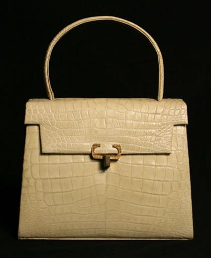 Appraisal: Cream alligator purse s With a textured gold latch gold