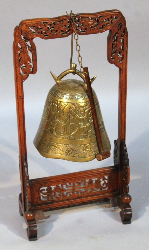 Appraisal: A Chinese hardwood table gong with a heavily carved surround