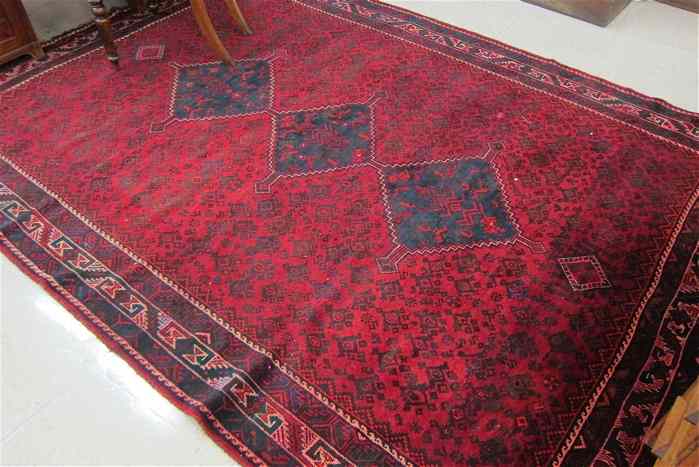 Appraisal: PERSIAN BELOUCHI TRIBAL CARPET featuring a column of three diamond