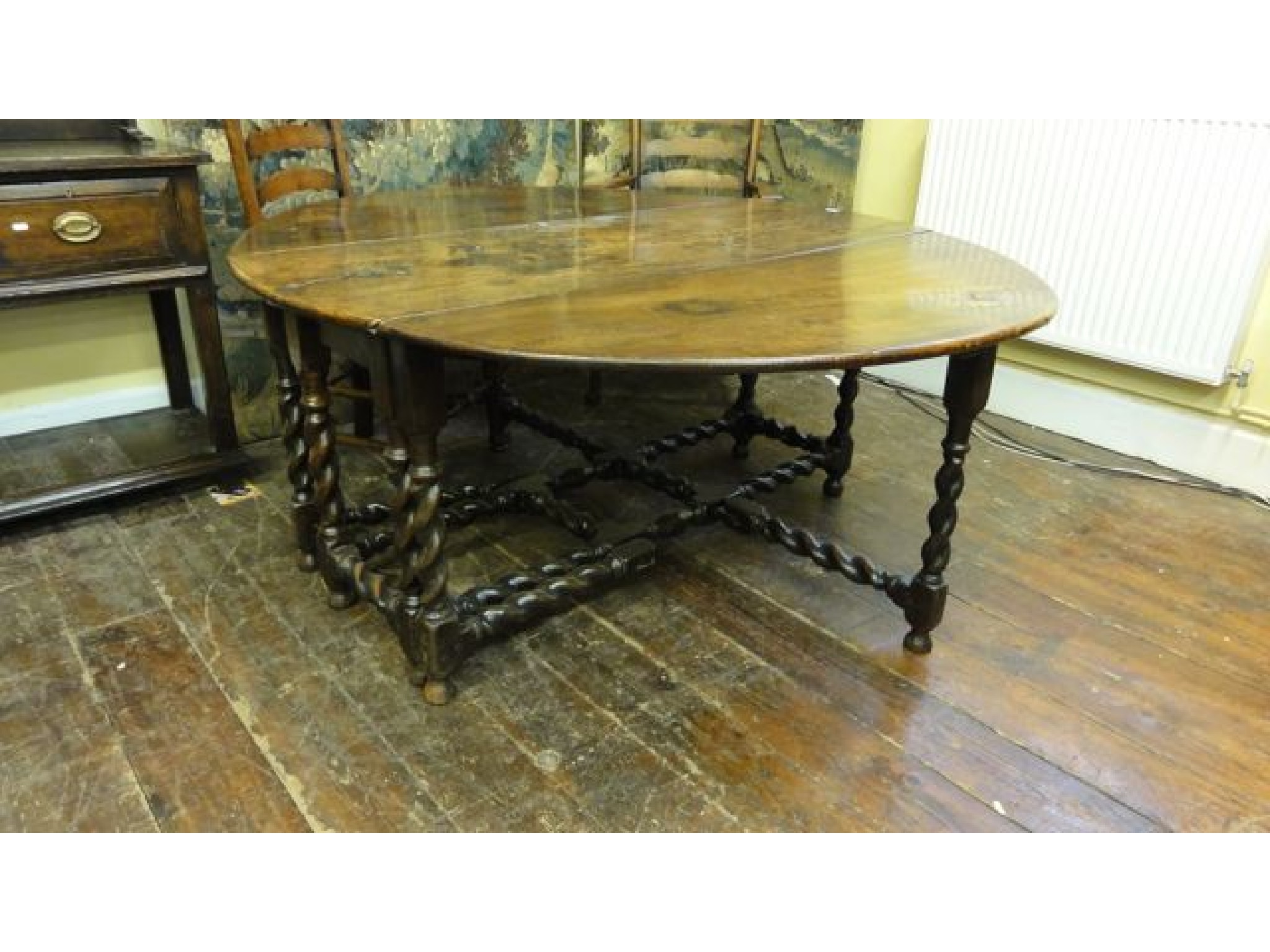 Appraisal: A large antique oak gateleg dining table the top constructed