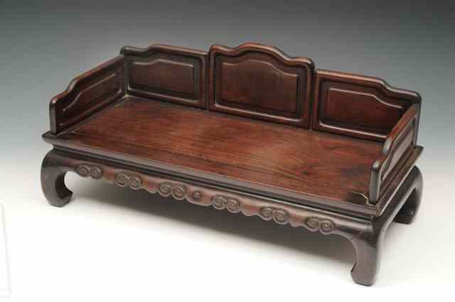 Appraisal: A CHINESE HARDWOOD SMALL MODEL BENCH SETTEE with panel back