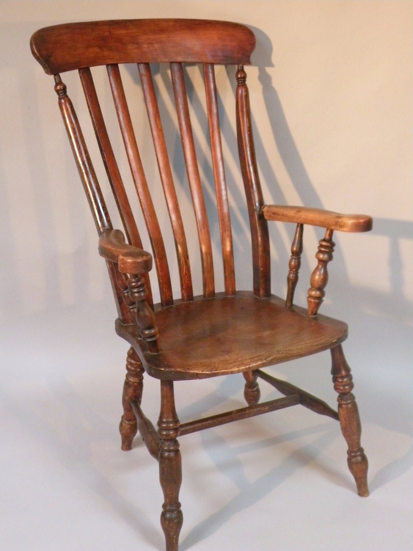 Appraisal: A thC ash and elm grandfather chair the comb top