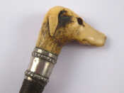 Appraisal: A riding crop the horn handle carved as a hound