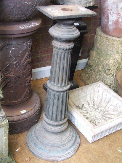 Appraisal: A VICTORIAN CAST IRON FLUTED COLUMN on circular stepped base