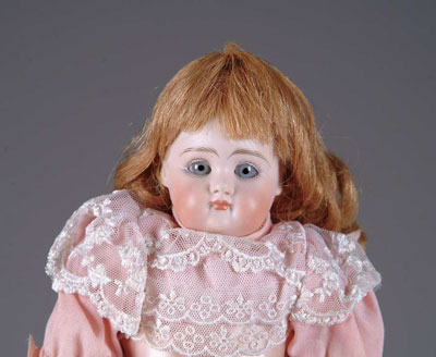 Appraisal: CLOSE-MOUTHED SHOULDER HEAD GERMAN DOLL Glass-eyed shoulder head on kid