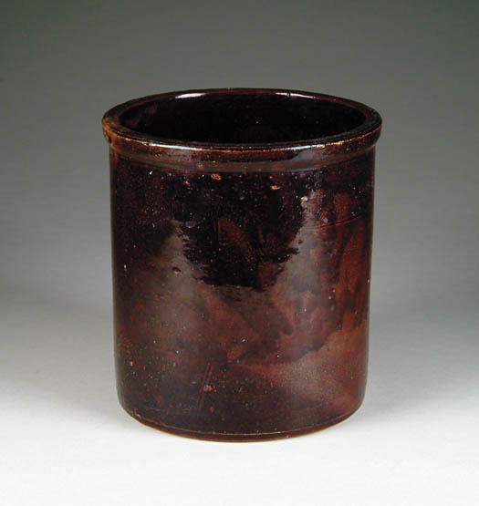 Appraisal: GLAZED STONEWARE JAR The dark brown glaze with mottled dripping