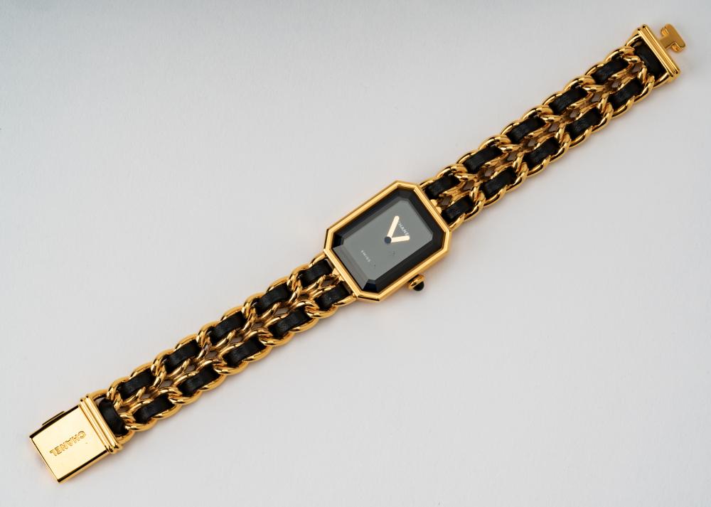 Appraisal: CHANEL GOLD-PLATE LEATHER WATCHComprising a cut-corner rectangular shape minimalist black