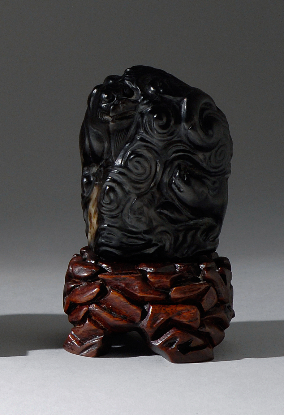 Appraisal: BLACK AND WHITE JADE FINIAL Ming DynastyIn the form of