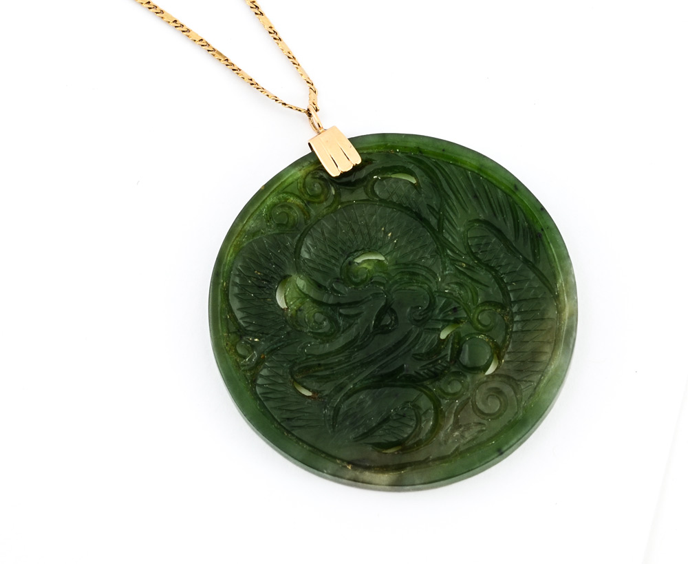 Appraisal: ORIENTAL CARVED GREEN STONE PENDANT Pierce carved green to grey