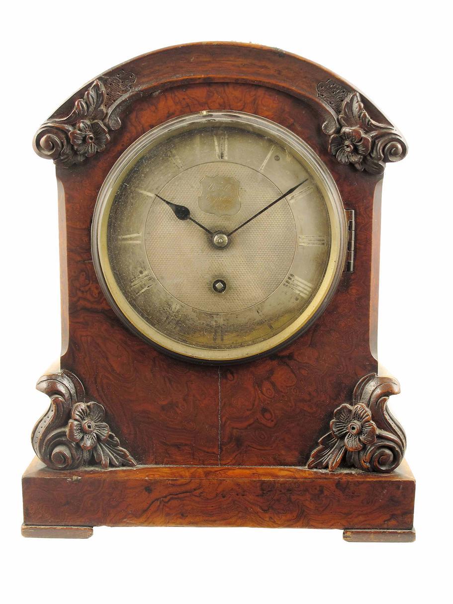 Appraisal: A Victorian carved and burr walnut mantel timepiece