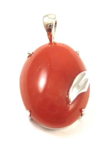 Appraisal: CORAL AND FOURTEEN KARAT WHITE GOLD PENDANT set with an