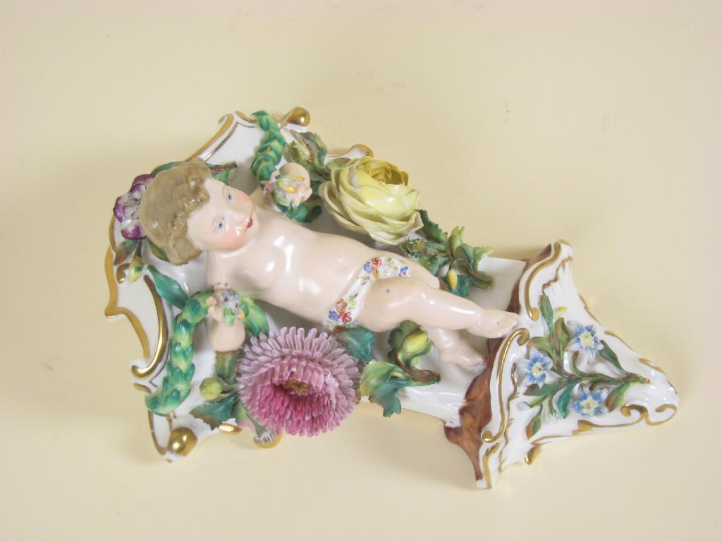 Appraisal: A th Century porcelain Wall Pocket with cherub supports floral