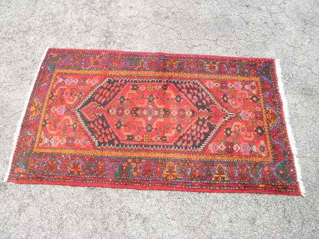 Appraisal: Oriental style wool pile carpet Red black orange and green