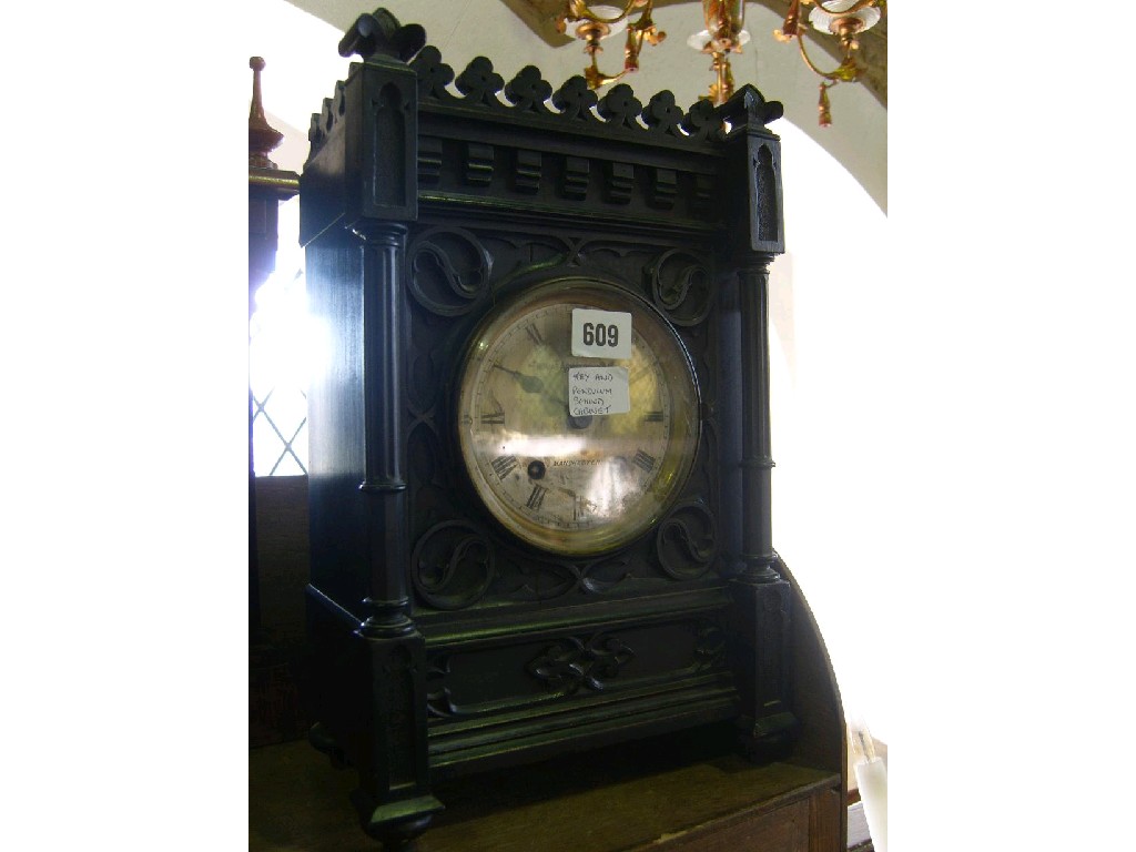 Appraisal: A late th century ebonised oak mantel clock with carved