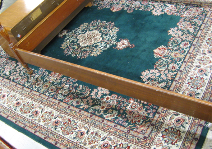 Appraisal: HAND KNOTTED ORIENTAL CARPET Indo-Kerman central floral medallion on plain