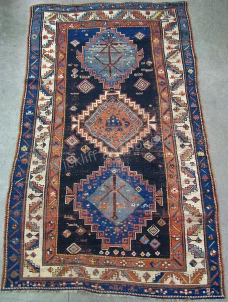 Appraisal: An antique Oriental rug traditional tribal design three medallions navy