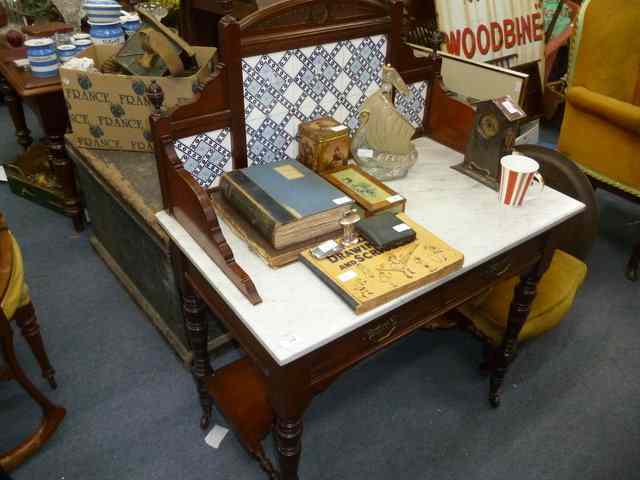 Appraisal: A VICTORIAN MAHOGANY MARBLE TOPPED WASHSTAND the raised tile back