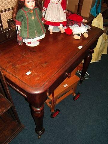 Appraisal: A Victorian walnut writing table with single drawer wide