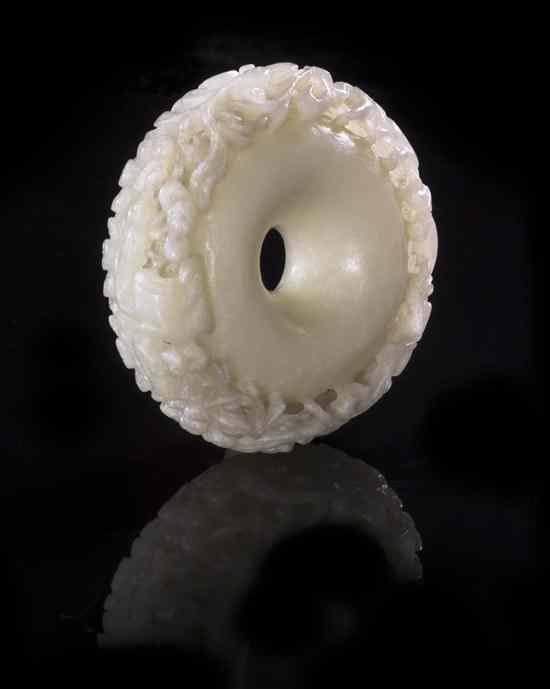 Appraisal: A White Jade Disk with Foliate Carving the thickly cut