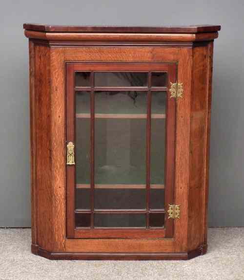 Appraisal: A George III oak and mahogany hanging corner cupboard fitted