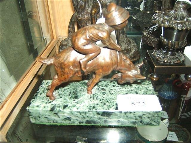 Appraisal: A small bronze sculpture of a boy riding on the