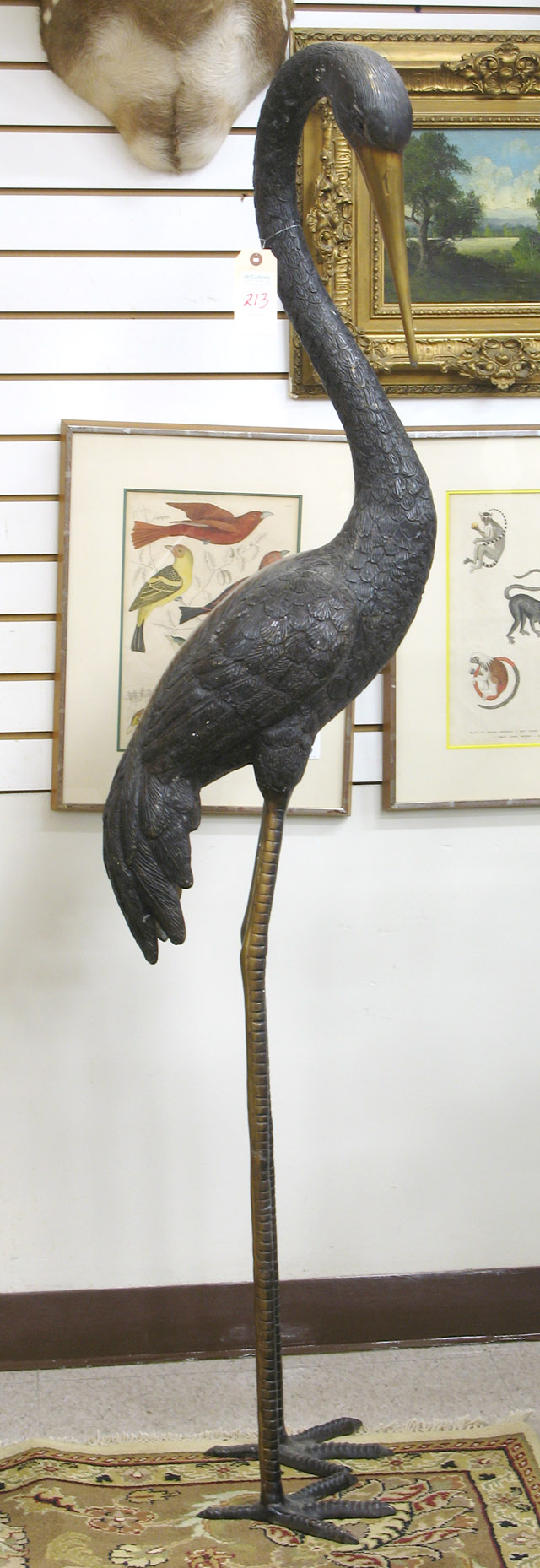 Appraisal: LIFE-SIZE BRONZE WILDLIFE SCULPTURE the standing figure of a crane