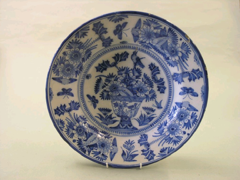 Appraisal: A th century Dutch Delft charger painted with a vase