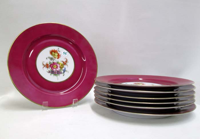 Appraisal: SEVEN BAVARIAN DECORATOR PLACE PLATES having wide cranberry red borders