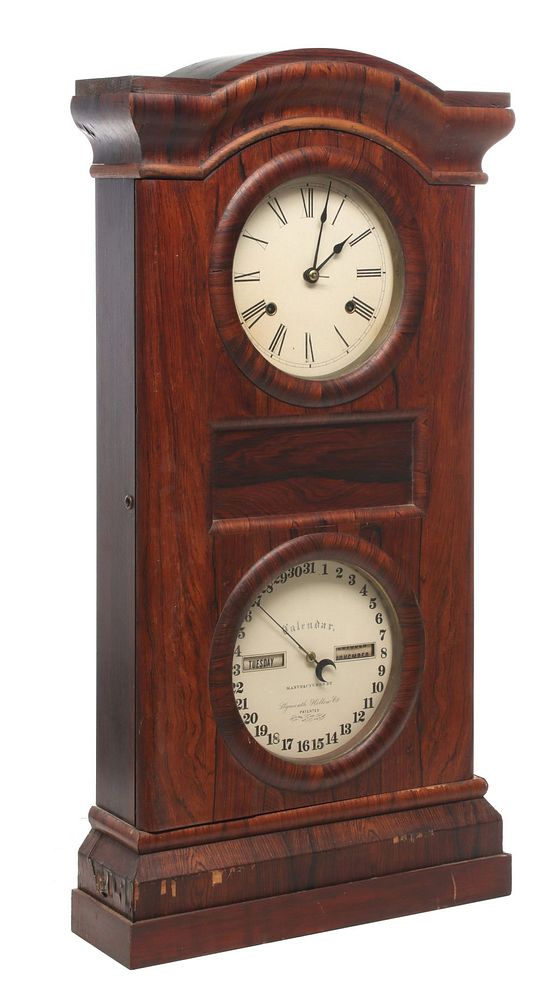 Appraisal: A SETH THOMAS ROSEWOOD CALENDAR DOUBLE DIAL CLOCK The arched