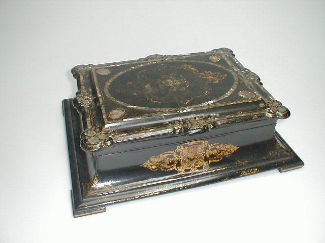 Appraisal: A Victorian ebonised paper mach box of rectangular swept form