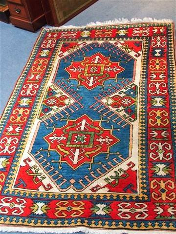 Appraisal: A PERSIAN RUG woven with two hooked medallions on a