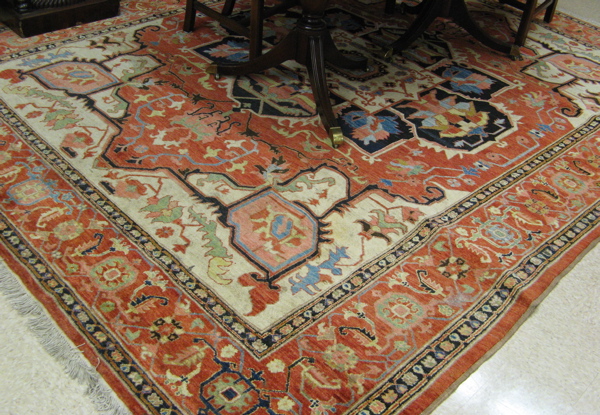 Appraisal: PAKISTANI HERIZ CARPET with central geometric medallion and surrounding stylized