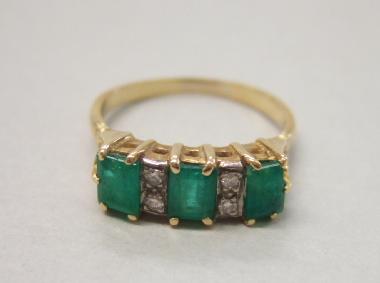 Appraisal: A gold emerald and diamond set ring mounted with three