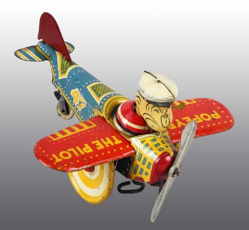 Appraisal: Tin Marx Popeye The Pilot Wind-Up Toy Description American Working